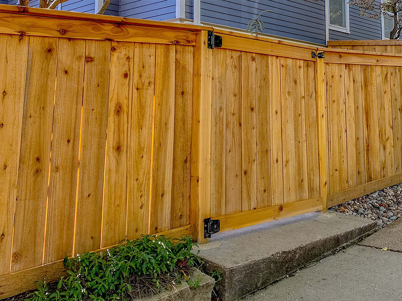 Staining wood fence before installation in Cedar Valley