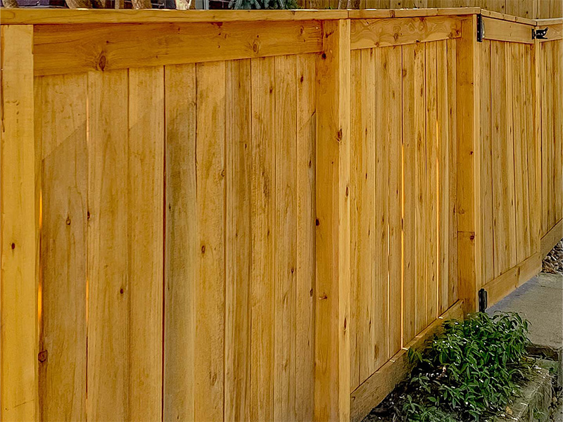 Staining wood fence before installation in Cedar Valley